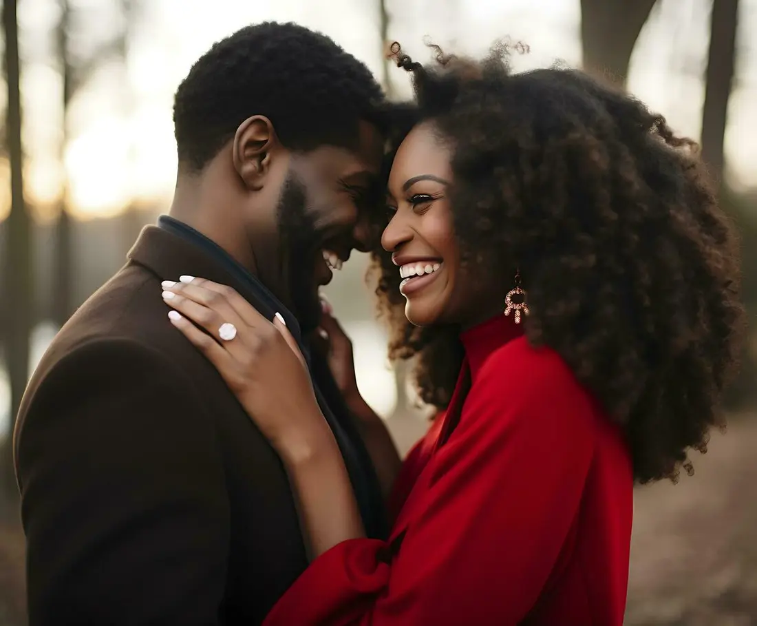 An engaged couple laughing together outdoors